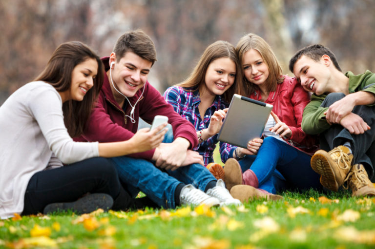 Group of young people using digital tablet and smart phone